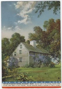 Image of saltbox house with patriotic label at bottom. 